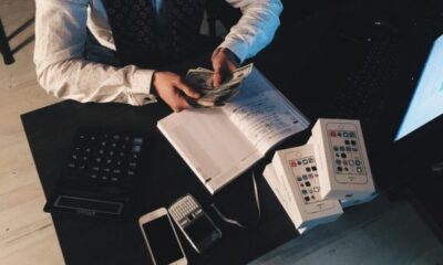 Person counting money at desk