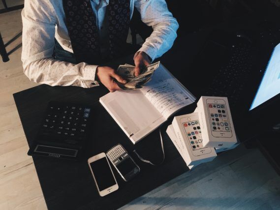 Person counting money at desk